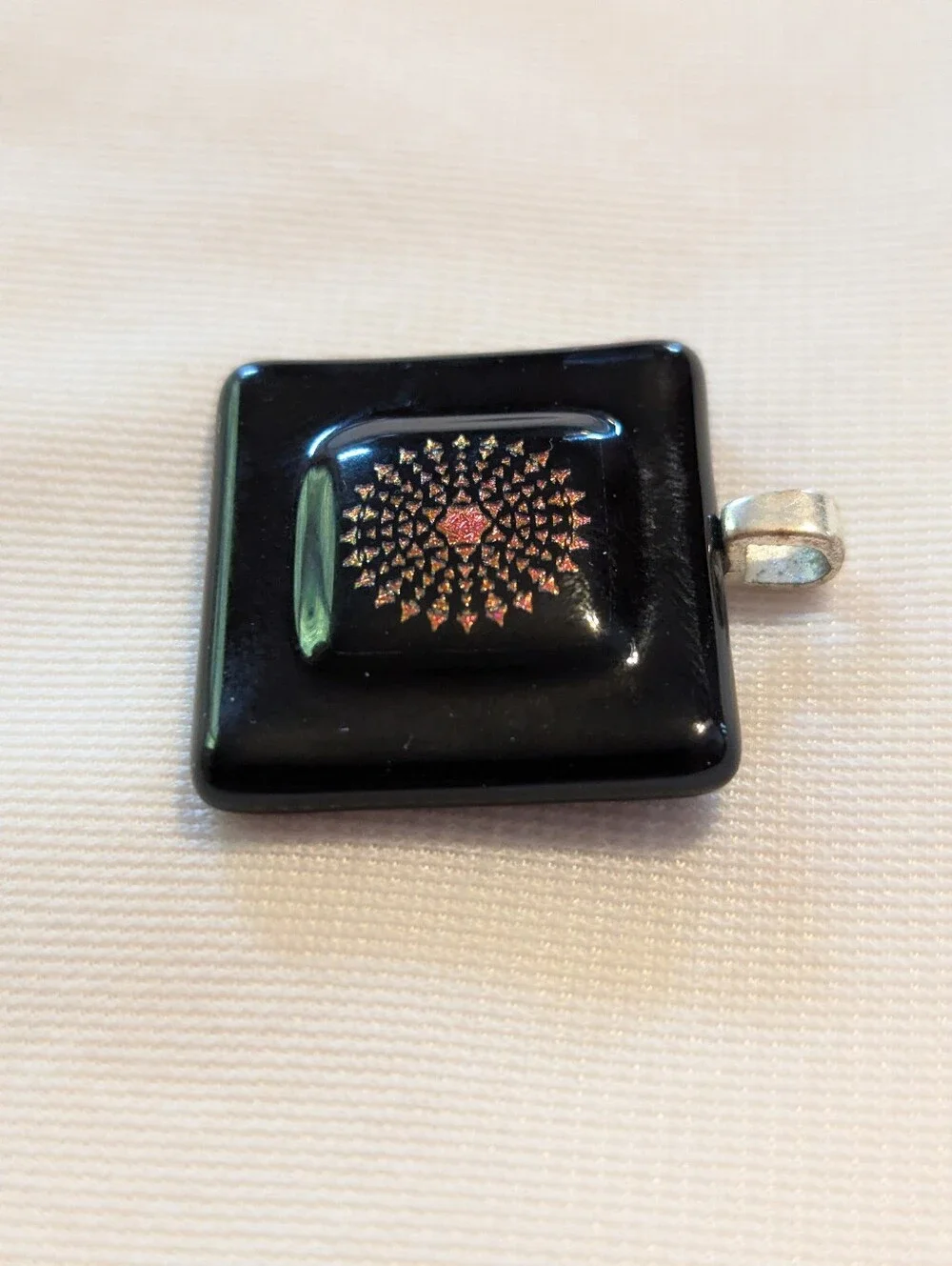 Black Pendant Featuring A Geometric Firework Pattern With Pink Center Handmade